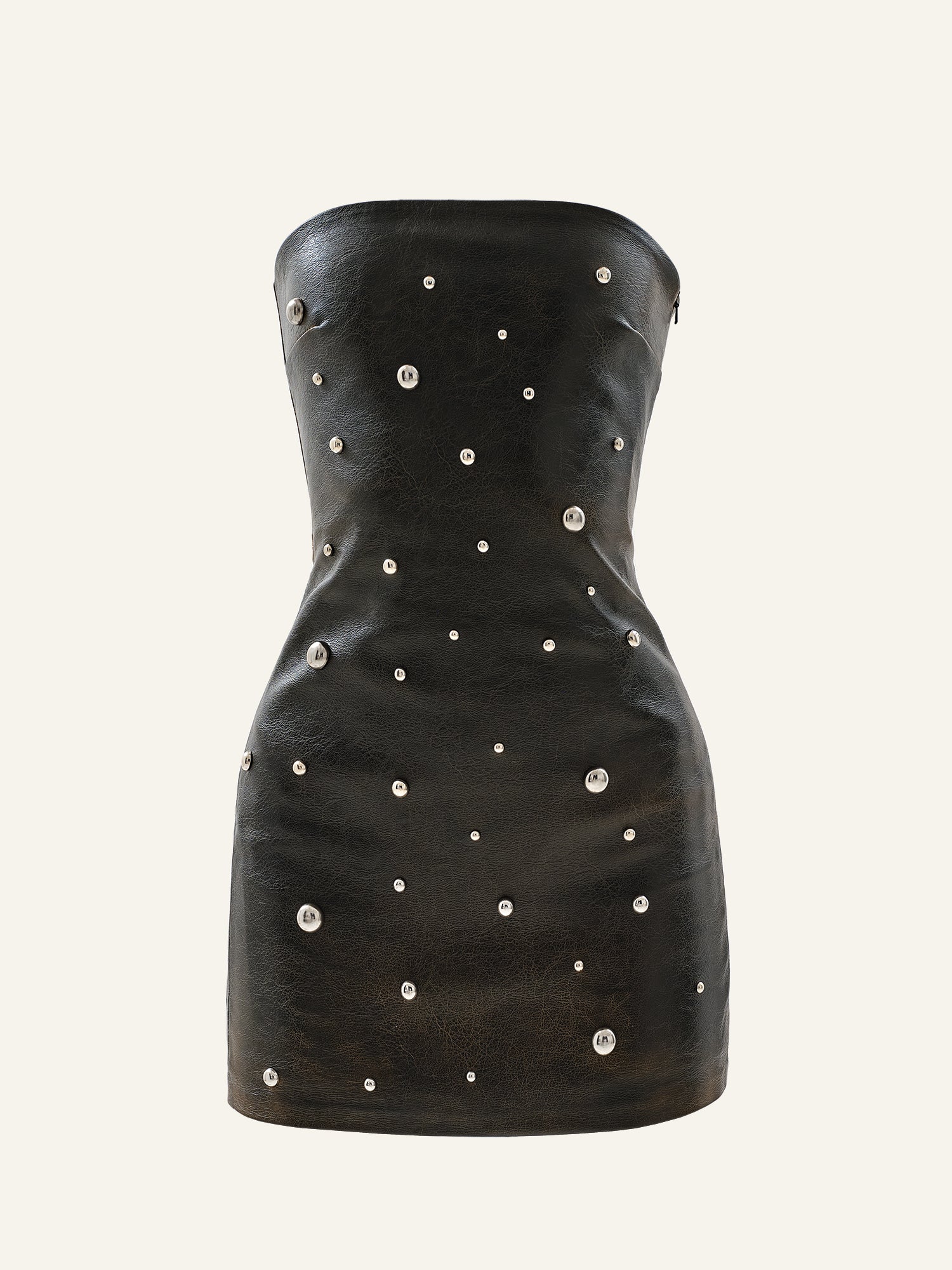 Product photo of a brown vegan leather mini dress decorated with round studs featuring shorts underneath