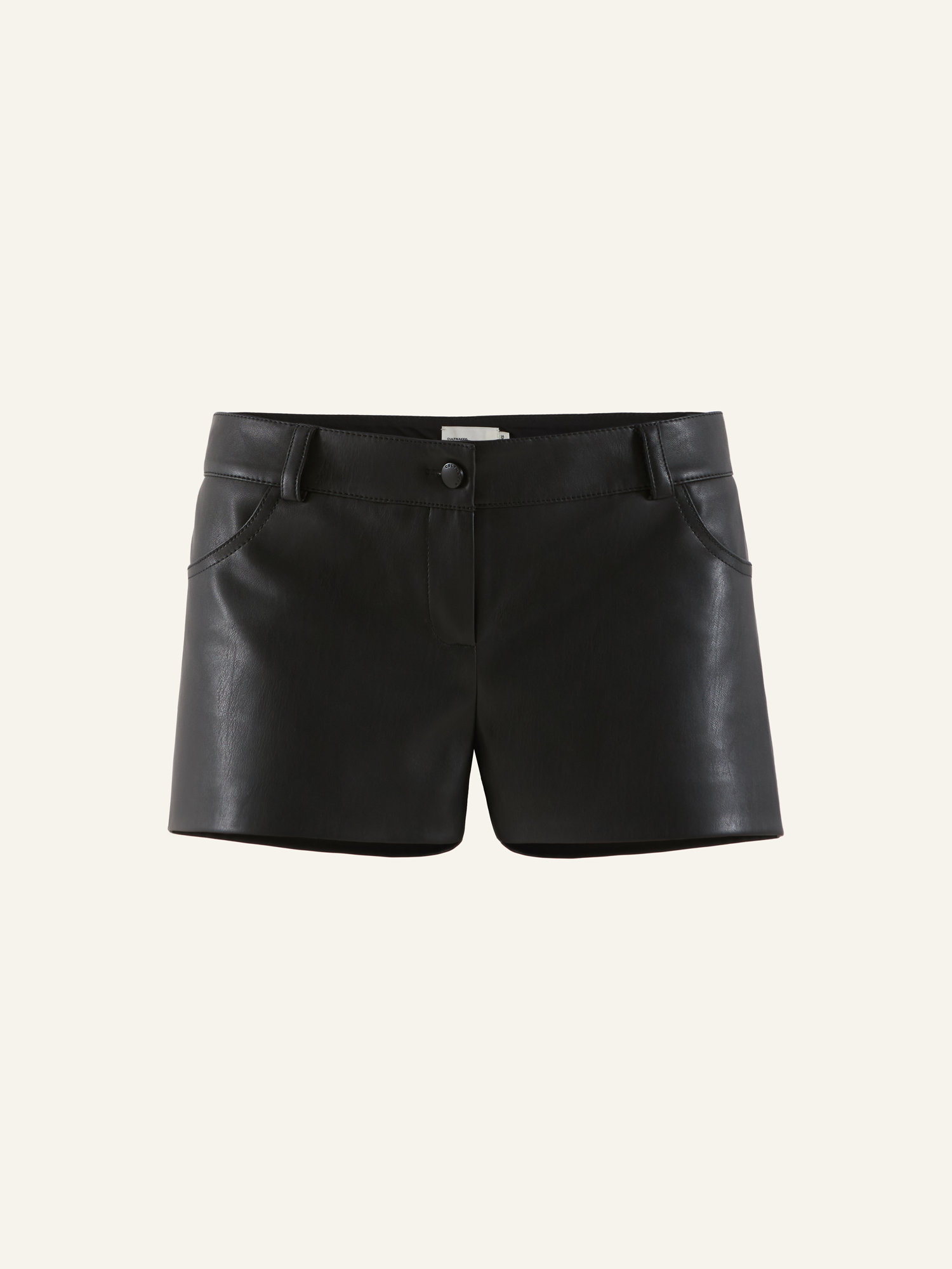 Product photo of a black vegan leather mini shorts with mid rise
