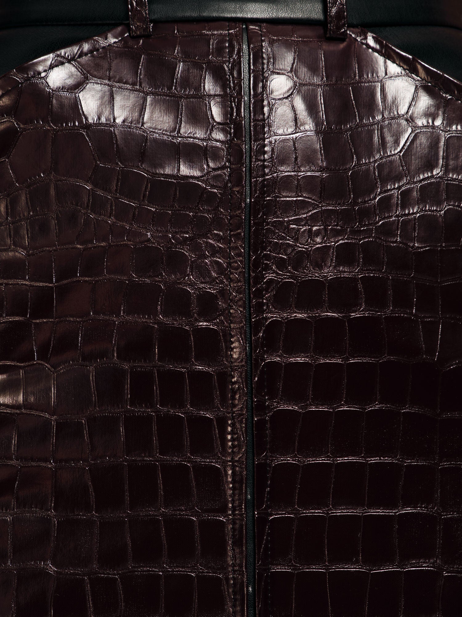 Extreme closeup of a plum crocodile printed vegan leather