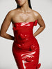Video of full and medium shots of a girl in a a red patent vegan leather tube dress decorated with hearts