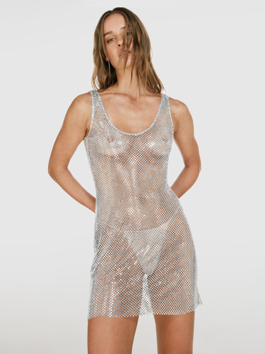 Cowboy shot of a girl in a grey net short tank dress decorated with rhinestones