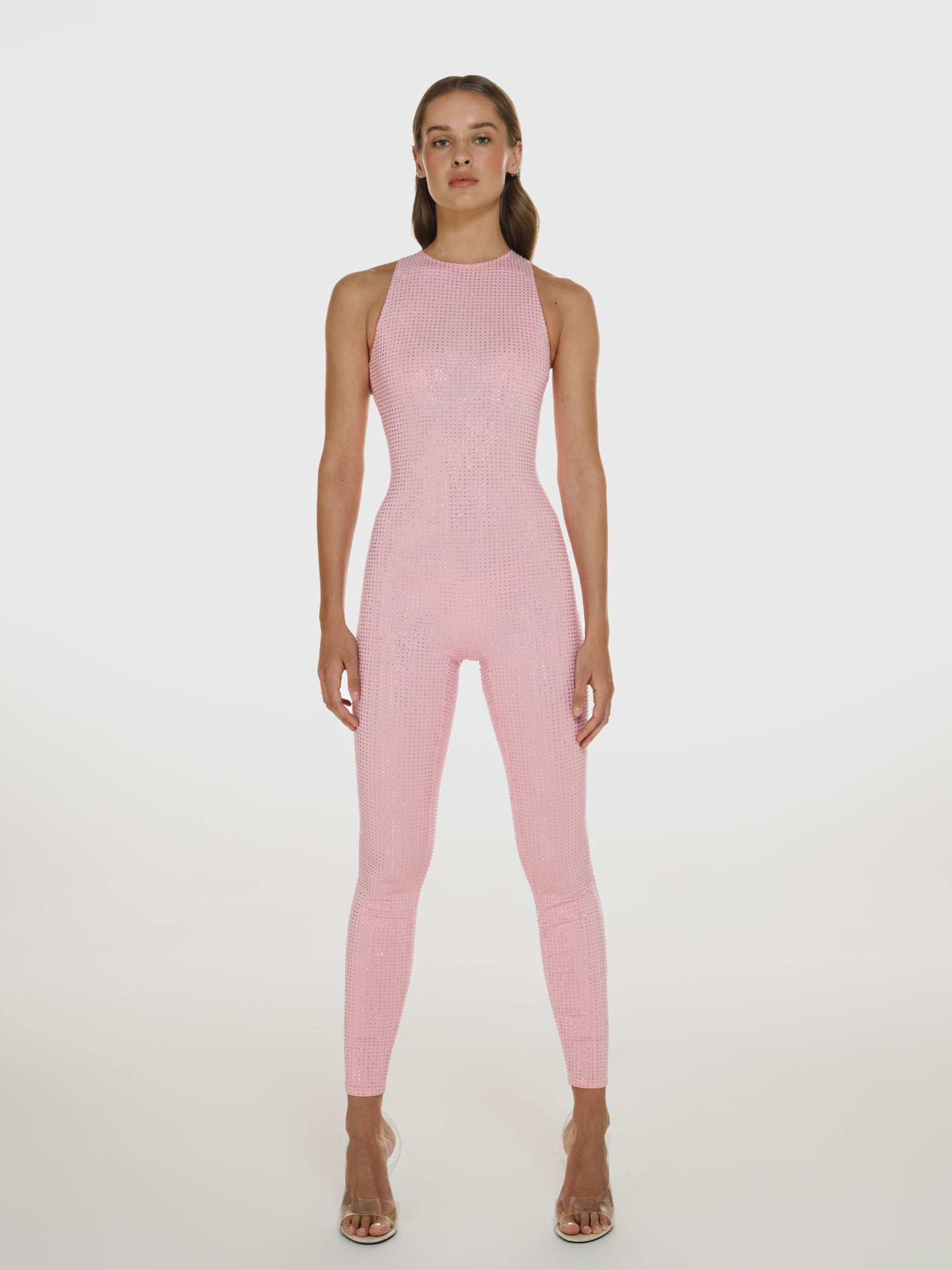 Full shot of a girl in a pink sleeveless jumpsuit decorated with Swarovski crystals