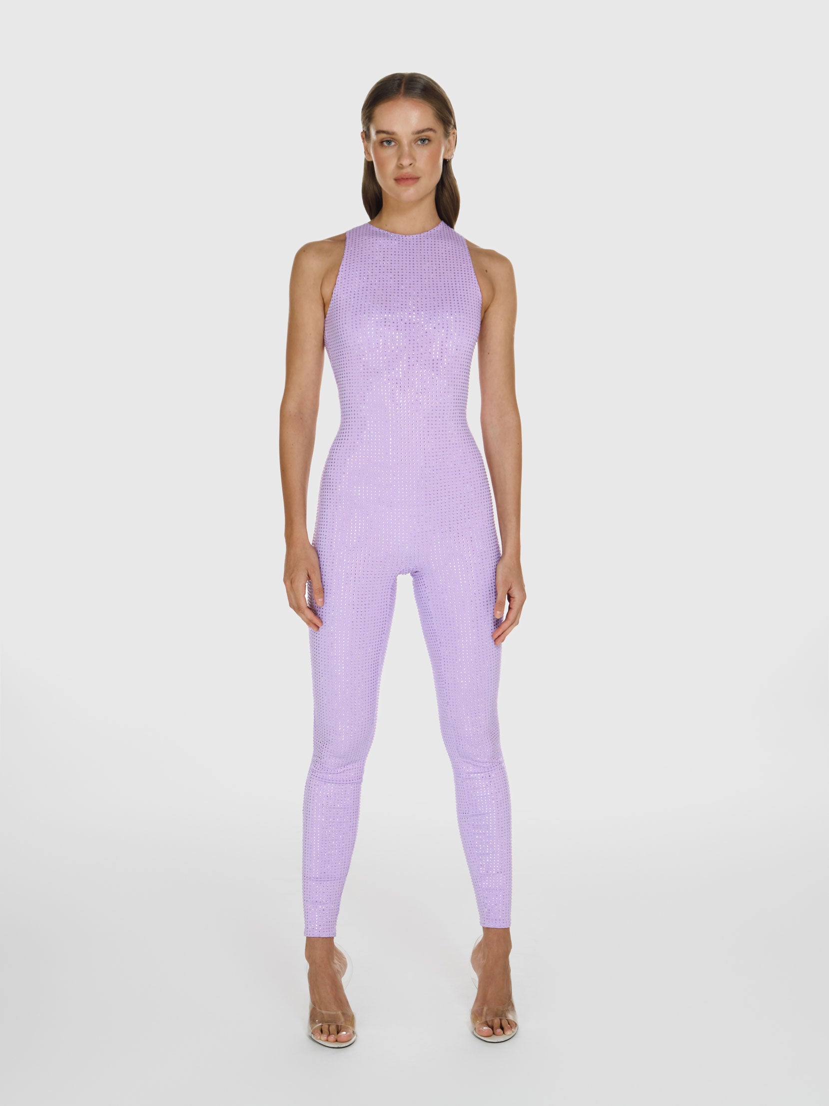 Full shot of a girl in a purple sleeveless jumpsuit decorated with Swarovski crystals