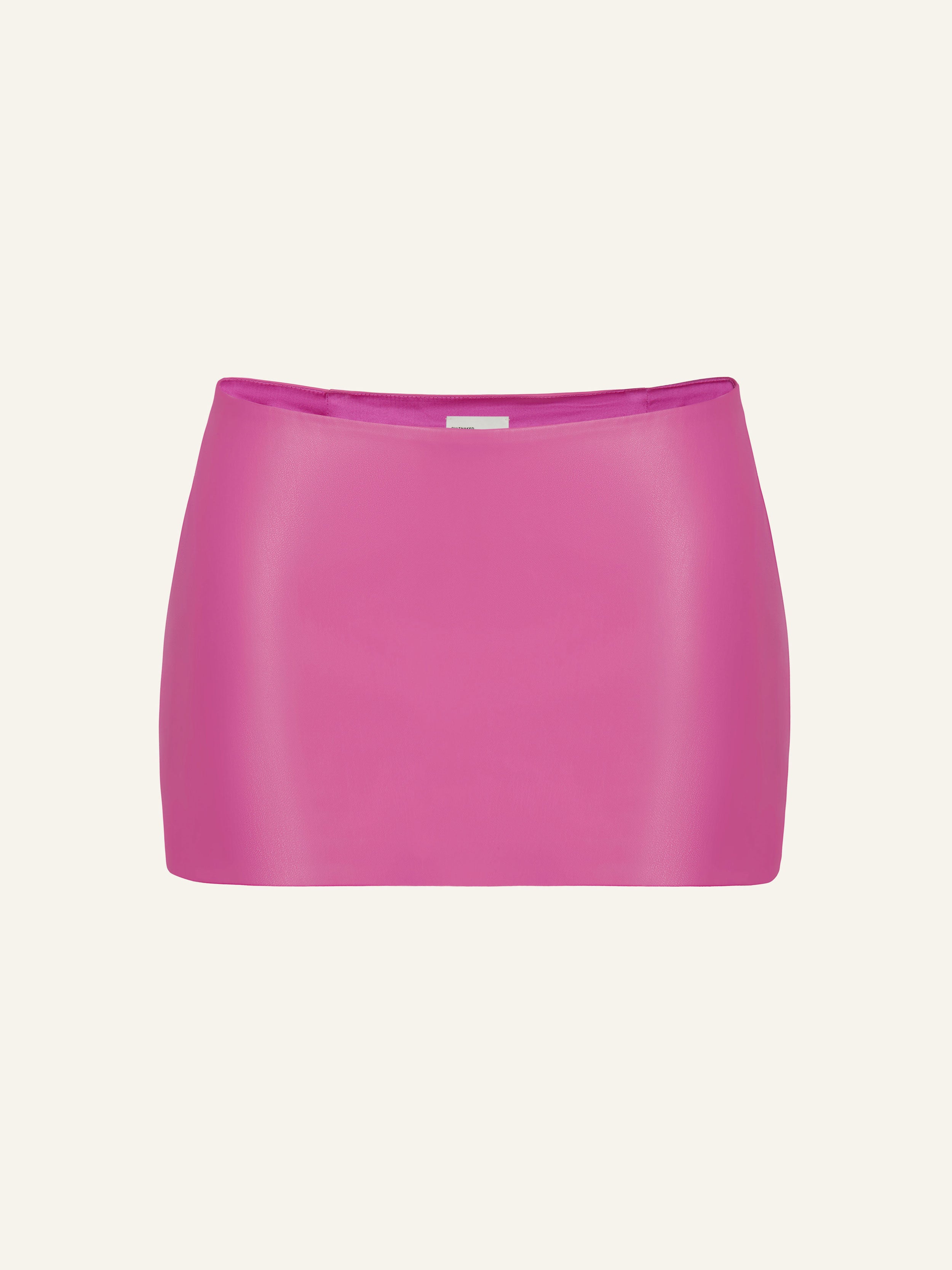 Product photography of a pink vegan leather low rise mini skort
