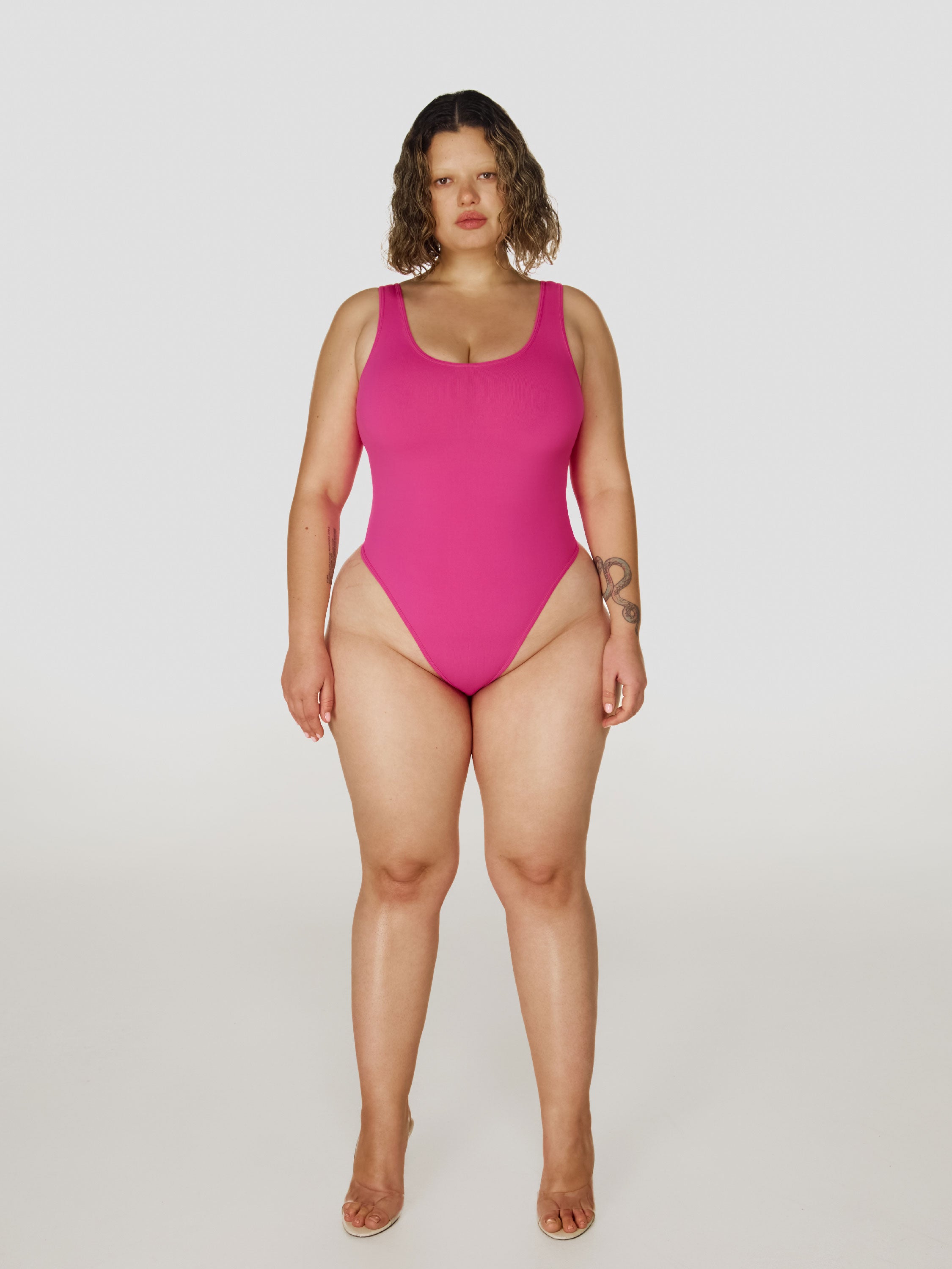 Full shot of a girl in a pink sleeveless bodysuit
